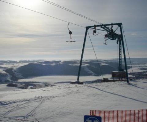 Ski lift on snow-covered mountain.