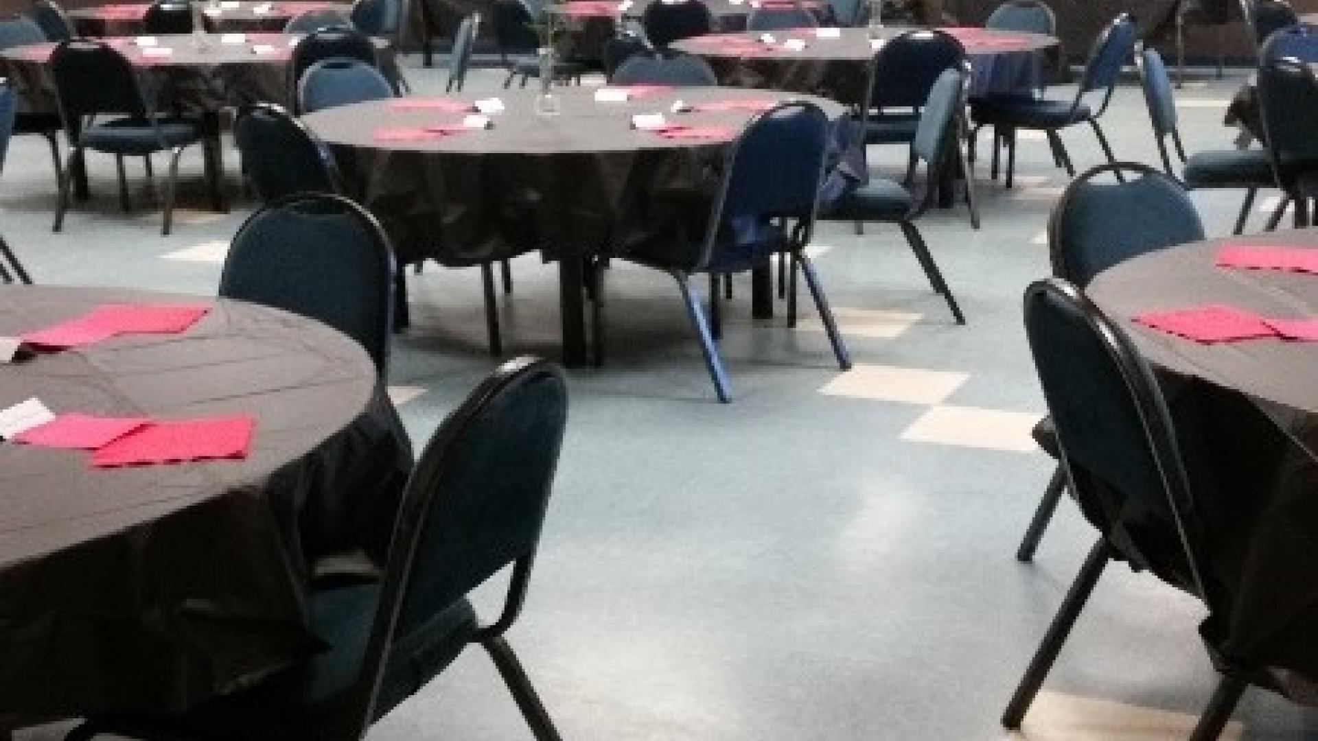Tables and chairs spread throughout multi-purpose room.