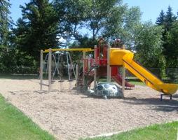 Slide and swing set on park.