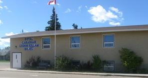 Exterior of rectangular building. There is a Canadian flag on a pole in front of the building.