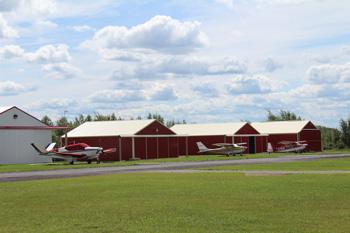 Row of small hangars on airstrip